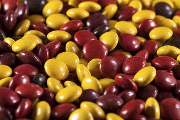 Halloween candy, autumn colored chocolate background