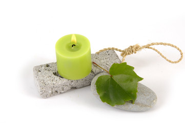 green burning candle and leaf