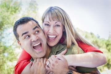 Fototapeta premium Attractive Mixed Race Couple Piggyback at the Park