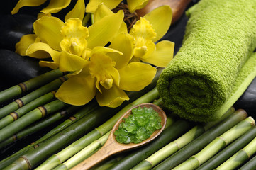 herbal salt in spoon and roller towel with orchid