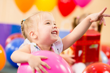 Fototapeta na wymiar joyful kid girl on birthday party