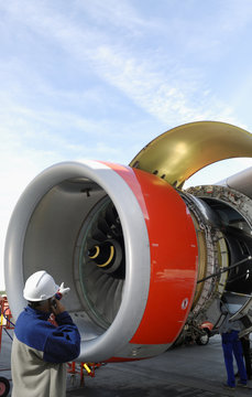 airplane mechanic in front of jet engine