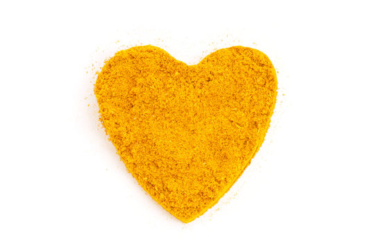 Heap ground Curry (Madras Curry) isolated in heart shape on whit