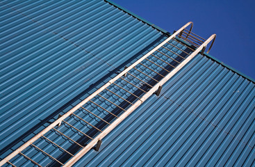 metal ladder on blue metal wall