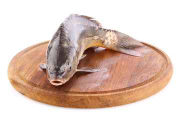 Obraz premium fresh fish (carp) on wooden board