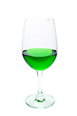 Green juice in a wine glass.
