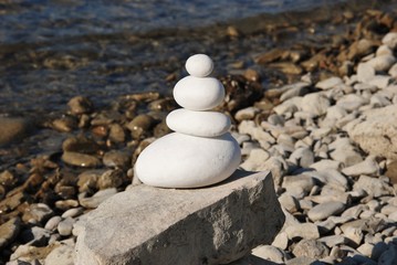 Fototapeta na wymiar round stones stacked background water