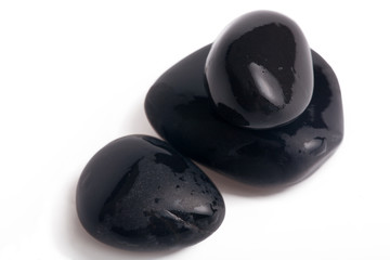 three wet stones with shadows