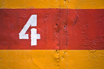 Yellow and red painted metal texture with white digit 4