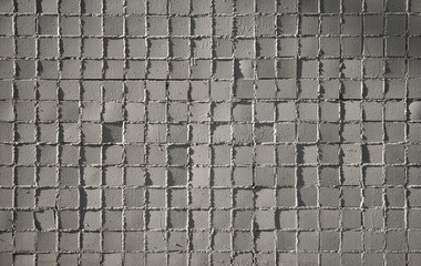 Small gray mosaic tiles on a wall