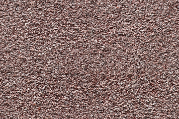 Seamless background texture of red granite chips panel