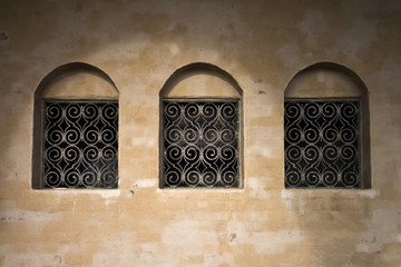 Old wall with three ancient windows background texture