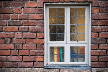 Background texture of old red brick wall with window