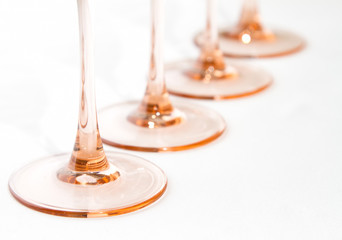 Pink stem wine glasses in a row
