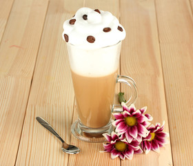 glass of fresh coffee cocktail awith flower on wooden