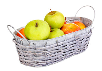 Ripe apples in basket isolated on white