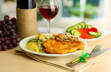 Roast chicken cutlet with boiled potatoes and vegetables, glass
