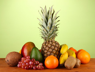 still life of fruit on a table on a green background