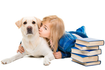 girl kissing her Labrador retriever on isolated white