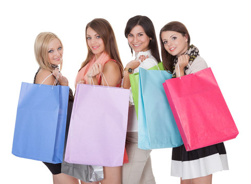 Four happy female shoppers