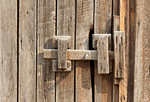 Close-up of a vintage wooden latch on a building