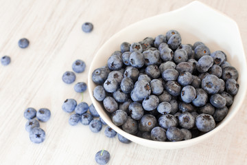 White bowl cup with fresh ripe blueberries