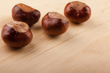 Chestnut fruit on a wooden table.