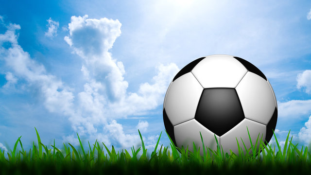 3D football in green grass on blue sky
