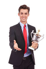 business man handing a trophy  and handshaking