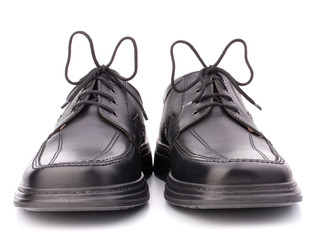 Black glossy man’s shoes with shoelaces