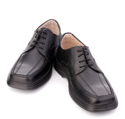 Black glossy man’s shoes with shoelaces