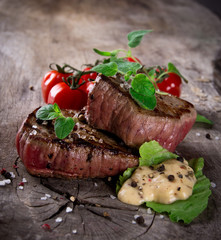 Grilled bbq steaks with fresh herbs and tomatoes