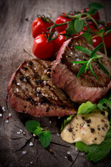 Grilled bbq steaks with fresh herbs and tomatoes