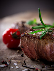 Grilled bbq steaks with fresh herbs and tomatoes