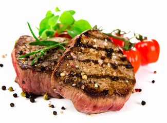 Grilled bbq steaks on white background