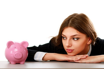 Young beautiful woman sitting with piggy bank (money box)