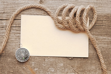 ropes and compass on old vintage ancient paper background textur