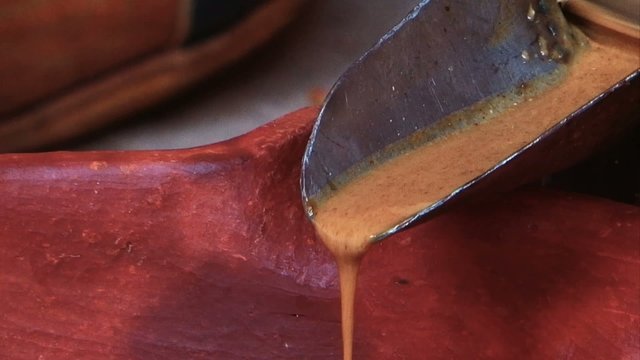 traditional methods of extracting Argan vegetable oil, a Moroccan specialty. The video may feature women or men working with handcrafted tools to crush the Argan fruit and extract its precious oil.