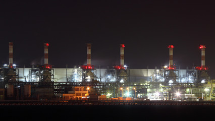 Oil refinery illuminated at night. Abu Dhabi, UAE