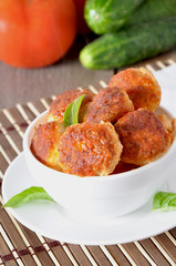 meatballs in tomato sauce, decorated with leaves of basil 