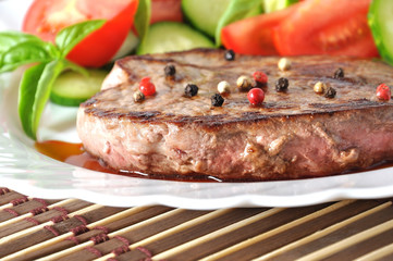Closeup of grilled beef steak with fresh vegetables 