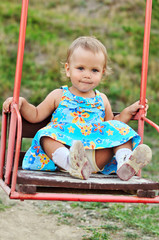 toddler girl on swing