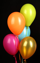 Fototapeta na wymiar colorful balloons on black background close-up