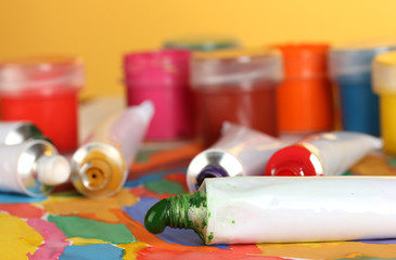 tubes with colorful watercolor and jars with gouache