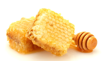 golden honeycombs and wooden drizzler with honey isolated
