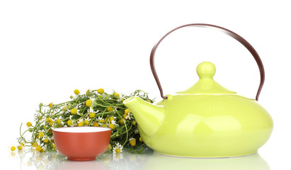 Teapot and cup with chamomile tea isolated on white
