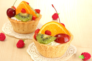 sweet cake with fruits on wooden table