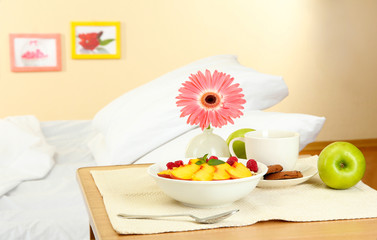 light breakfast on the nightstand next to the bed