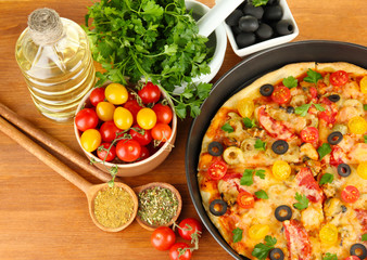 colorful composition of delicious pizza, vegetables and spices