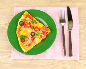 plate with a slice of delicious pizza on wooden background